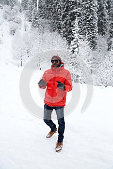 African American Cheerful black man in ski suit in snowy winter outdoors, Almaty, Kazakhstan