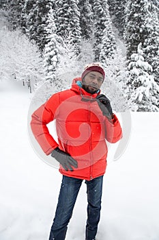 African American Cheerful black man in ski suit in snowy winter outdoors, Almaty, Kazakhstan