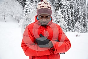 African American Cheerful black man in ski suit in snowy winter outdoors, Almaty