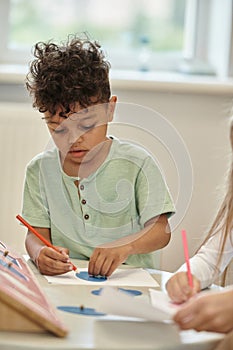 african american child paining with pencil