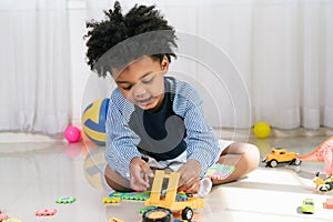 African American child play truck and airplane toy at home