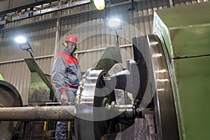 African American CNC Machine Operator Monitoring The Train Wheel Manufacturing Process On Lathe Machine In A Train Factory