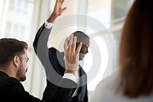 African American coach holding teambuilding meeting with colleagues photo