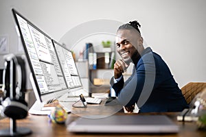 African American Coder Using Computer At Desk