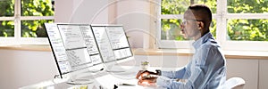 African American Coder Using Computer At Desk