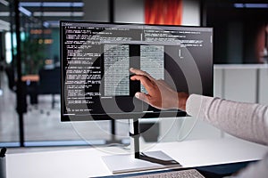 African American Coder Using Computer At Desk