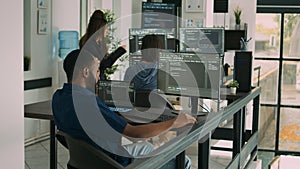 African american coder writing programming language on computer