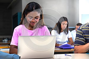 African american college student using laptop in class.Teen female black high school student doing homework. Copy space.