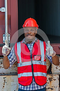 African American Container Warehouse Worker. Foreman control loading Containers box from Cargo freight ship for import export.