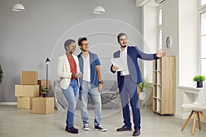 An African-American couple buys a house, a real estate agent shows a large house.