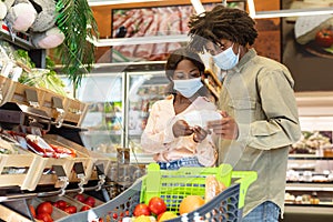 African American Couple Choosing Vegetables Doing Grocery Shopping Together Indoor