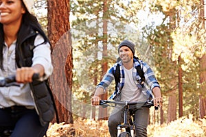 African American Couple Cycling Through Fall Woodland