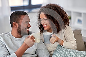 African american couple drinking coffee at home