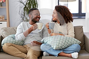 African american couple drinking coffee at home