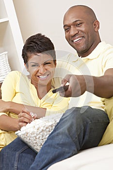 African American Couple Eating Popcorn With Remote
