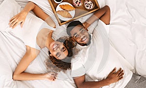 African-american couple enjoying healthy breakfast in bed