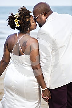 African American couple getting married at the beach