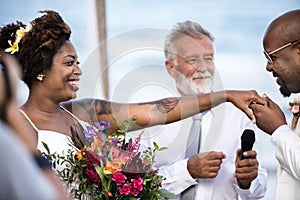 African American couple getting married at the beach photo
