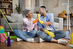 African American Couple Giving High Five Cleaning House Together Indoors