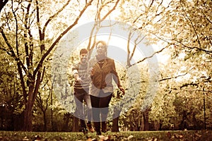 African American couple running and playing in park tog