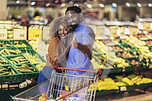 African american couple shopping for healthy fresh food at produce section of supermarket