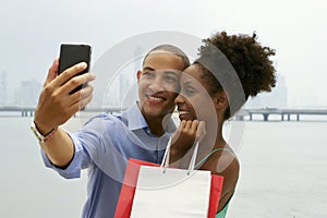 African American Couple Shopping Taking Selfie With Mobile Phone