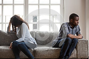 African American couple sitting separately after quarrel