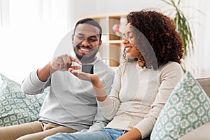 African american couple with smart speaker at home