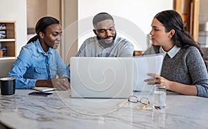 African American couple talking to their financial advisor at home