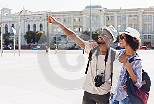African-american couple of tourists sightseeing in city