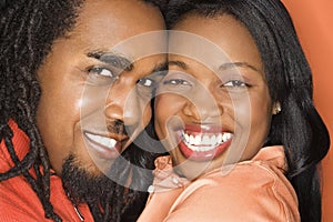 African-American couple wearing orange clothing.