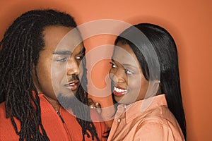 African-American couple wearing orange clothing.