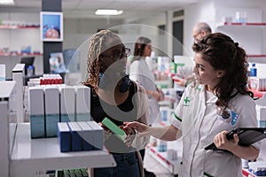 African american customer asking for pharmacist help
