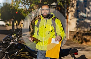 African american delivery man with envelope and delivery check sheet
