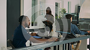 African american developer using laptop to write code and display system information