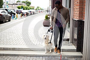 African american disabled man with helpful dog