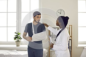 African american doctor conduct medical examination on patient with hand injury