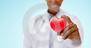 African american doctor hand holding red heart