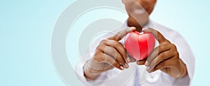 African american doctor hands holding red heart