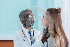 african american Doctor palpating patient lymph