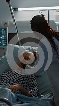 African american doctor placing oxygen tube on patient