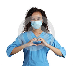 African-American doctor in protective mask making heart with hands on white background