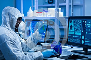 African-american doctor in protective suit is doing a science experiments and developing vaccine in a modern lab