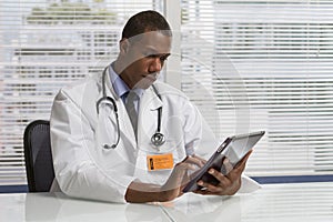 African American doctor using electronic tablet, horizontal
