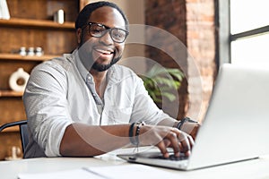 African American employee typing on a laptop