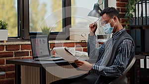 African american employee working on financial report in startup offce