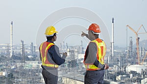 African American engineer is discussing on furture plan while looking over the petroleum and crude oil refinery factory for power