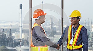 African American engineer and security team handshaking for agreement in partnership project for petroleum and crude oil refinery