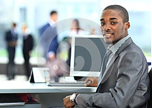 African American entrepreneur displaying computer laptop in office