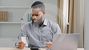 African American ethnic man bearded businessman manager business company CEO checking budget expenses check bill loan